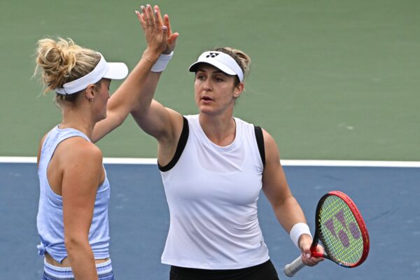 Gabriela Dabrowski high fives Erin Routliffe (back to camera) at the US Open.