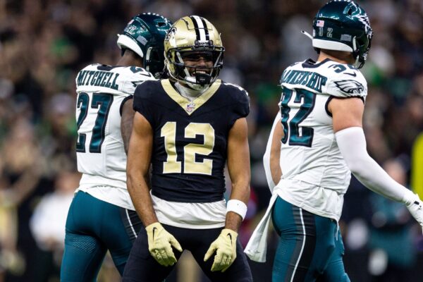 Sep 22, 2024; New Orleans, Louisiana, USA; New Orleans Saints wide receiver Chris Olave (12) reacts to making a first down reception against Philadelphia Eagles safety Reed Blankenship (32) during the first half at Caesars Superdome. Mandatory Credit: Stephen Lew-Imagn Images