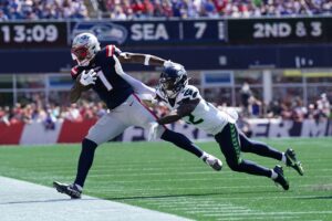 New England Patriots wide receiver Ja'Lynn Polk (1) is pushed out of bounds by Seattle Seahawks cornerback Tre Brown (22) in the second quarter at Gillette Stadium.