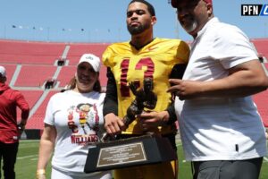 USC Trojans quarterback Caleb Williams (13) holds the Heisman Trophy with his parents during the Spring Game at Los Angeles Memorial Coliseum.