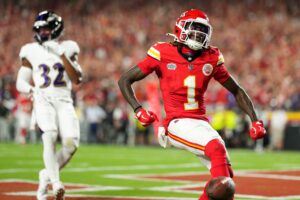 Kansas City Chiefs wide receiver Xavier Worthy (1) scores a touchdown against Baltimore Ravens safety Marcus Williams (32) during the first half at GEHA Field at Arrowhead Stadium. Mandatory Credit: Jay Biggerstaff-Imagn Images