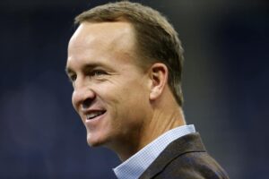 Former Indianapolis Colts Quarterback Peyton Manning smiles prior to the NFL game between the Tennessee Titans and Indianapolis Colts on November 18, 2018, at Lucas Oil Stadium in Indianapolis, IN.