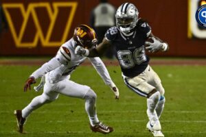 Dallas Cowboys wide receiver CeeDee Lamb (88) runs past Washington Commanders cornerback Tariq Castro-Fields (26) during the second half at FedExField.