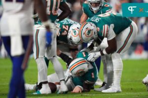 Miami Dolphins offensive tackle Liam Eichenberg (74) and tight end Jonnu Smith (9) attend to quarterback Tua Tagovailoa (1) after an apparent injury during the second half against the Buffalo Bills at Hard Rock Stadium. Mandatory Credit: Jasen Vinlove-Imagn