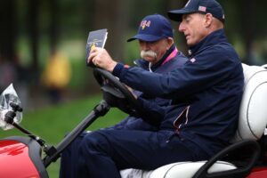 Mike ‘Fluff’ Cowan serving as Jim Furyk’s driver at Presidents Cup