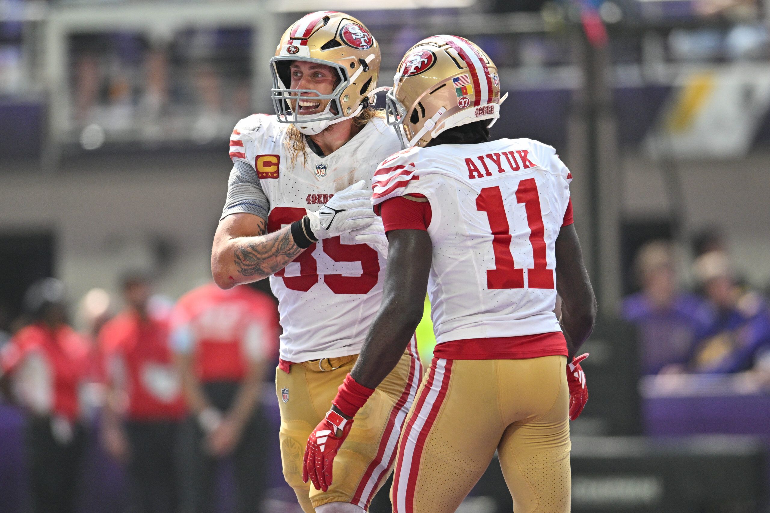 Sep 15, 2024; Minneapolis, Minnesota, USA; San Francisco 49ers tight end George Kittle (85) and wide receiver Brandon Aiyuk (11) react after a touchdown by Kittle during the second quarter against the Minnesota Vikings U.S. Bank Stadium. Mandatory Credit: Jeffrey Becker-Imagn Images