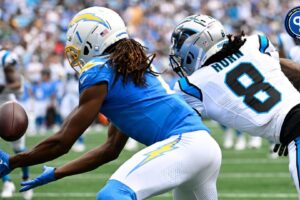 Los Angeles Chargers wide receiver Quentin Johnston (1) catches a touchdown pass as Carolina Panthers cornerback Jaycee Horn (8) defends in the first quarter at Bank of America Stadium.