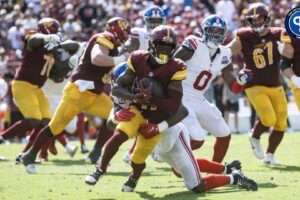 New York Giants linebacker Bobby Okereke (58) tackles Washington Commanders wide receiver Terry McLaurin (17) in the second half at Commanders Field.