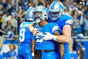 Detroit Lions running back David Montgomery (5) celebrates scoring a touchdown against Los Angeles Rams with center Frank Ragnow (77) during overtime at Ford Field in Detroit on Sunday, September 8, 2024.