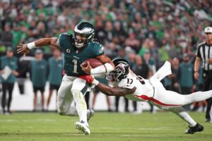 Sep 16, 2024; Philadelphia, Pennsylvania, USA; Philadelphia Eagles quarterback Jalen Hurts (1) is tackled by Atlanta Falcons linebacker Arnold Ebiketie (17) at Lincoln Financial Field. Mandatory Credit: Eric Hartline-Imagn Images