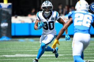 Carolina Panthers running back Chuba Hubbard (30) with the ball as Los Angeles Chargers cornerback Asante Samuel Jr. (26) defends in the first quarter at Bank of America Stadium.