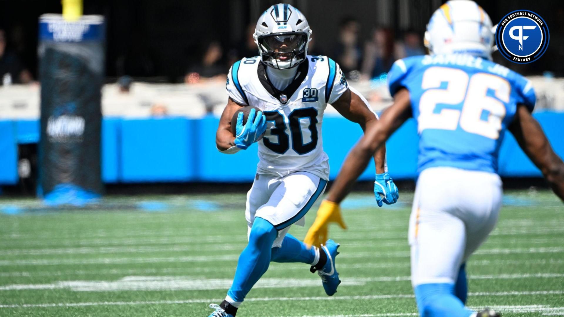 Carolina Panthers running back Chuba Hubbard (30) with the ball as Los Angeles Chargers cornerback Asante Samuel Jr. (26) defends in the first quarter at Bank of America Stadium.