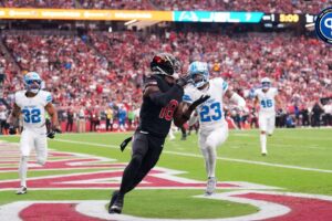 Arizona Cardinals wide receiver Marvin Harrison Jr. (18) catches a touchdown pass against the Detroit Lions during the first half at State Farm Stadium.