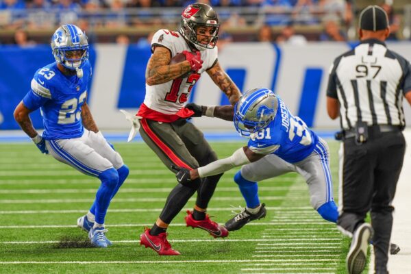 Tampa Bay Buccaneers wide receiver Mike Evans (13) is tackled by Detroit Lions safety Kerby Joseph (31) during the second half of the N.F.L. game against the Detroit Lions at Ford Field in Detroit on Sunday, Sept. 15, 2024. Bucaneers won 20-16.