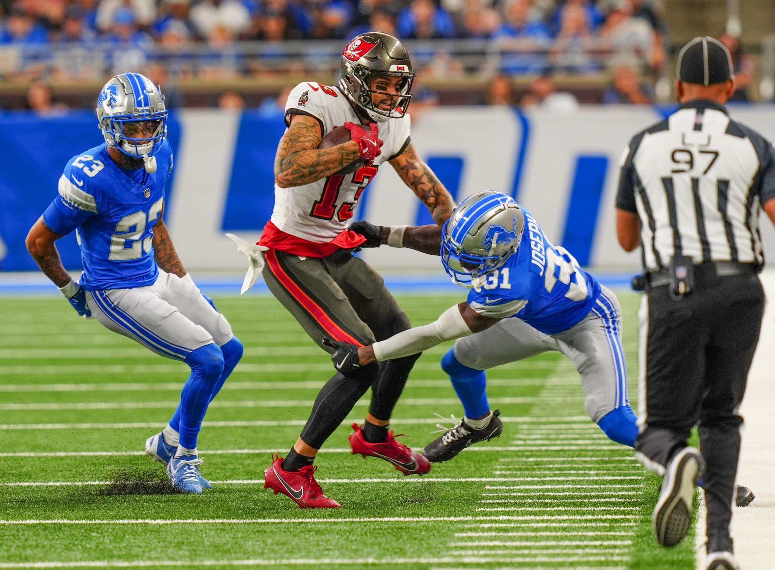 Tampa Bay Buccaneers wide receiver Mike Evans (13) is tackled by Detroit Lions safety Kerby Joseph (31) during the second half of the N.F.L. game against the Detroit Lions at Ford Field in Detroit on Sunday, Sept. 15, 2024. Bucaneers won 20-16.