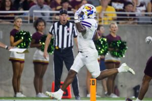 Kansas Jayhawks running back Devin Neal (4) celebrates as he scores a touchdown against the Arizona State Sun Devils in the second half at Mountain America Stadium.
