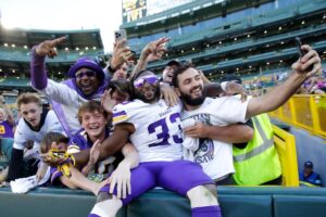 Minnesota Vikings running back Aaron Jones (33) does a Lambeau Leap with fans following a 31-29 victory against the Green Bay Packers Sunday, September 29, 2024, at Lambeau Field in Green Bay, Wisconsin.