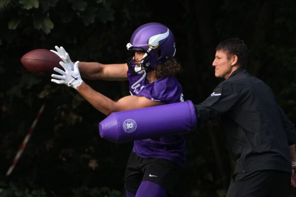 Oct 4, 2024; Watford, United Kingdom; Minnesota Vikings tight end T.J. Hockenson (87) catches the ball against tight ends coach Brian Angelichio during practice at The Grove. Mandatory Credit: Kirby Lee-Imagn Images
