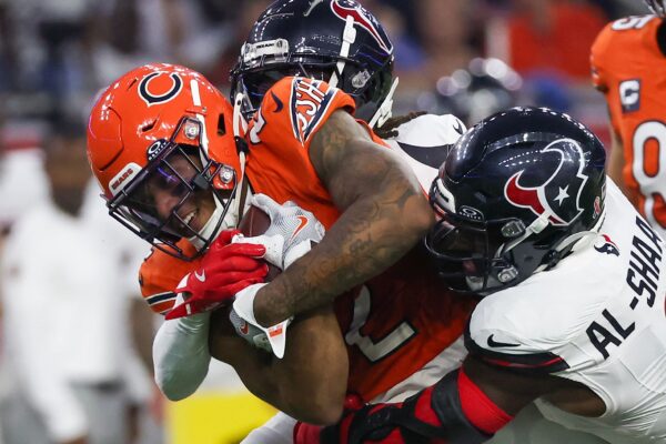 Sep 15, 2024; Houston, Texas, USA; Chicago Bears wide receiver DJ Moore (2) is tackled by Houston Texans linebacker Azeez Al-Shaair (0) in the first quarter at NRG Stadium. Mandatory Credit: Thomas Shea-Imagn Images
