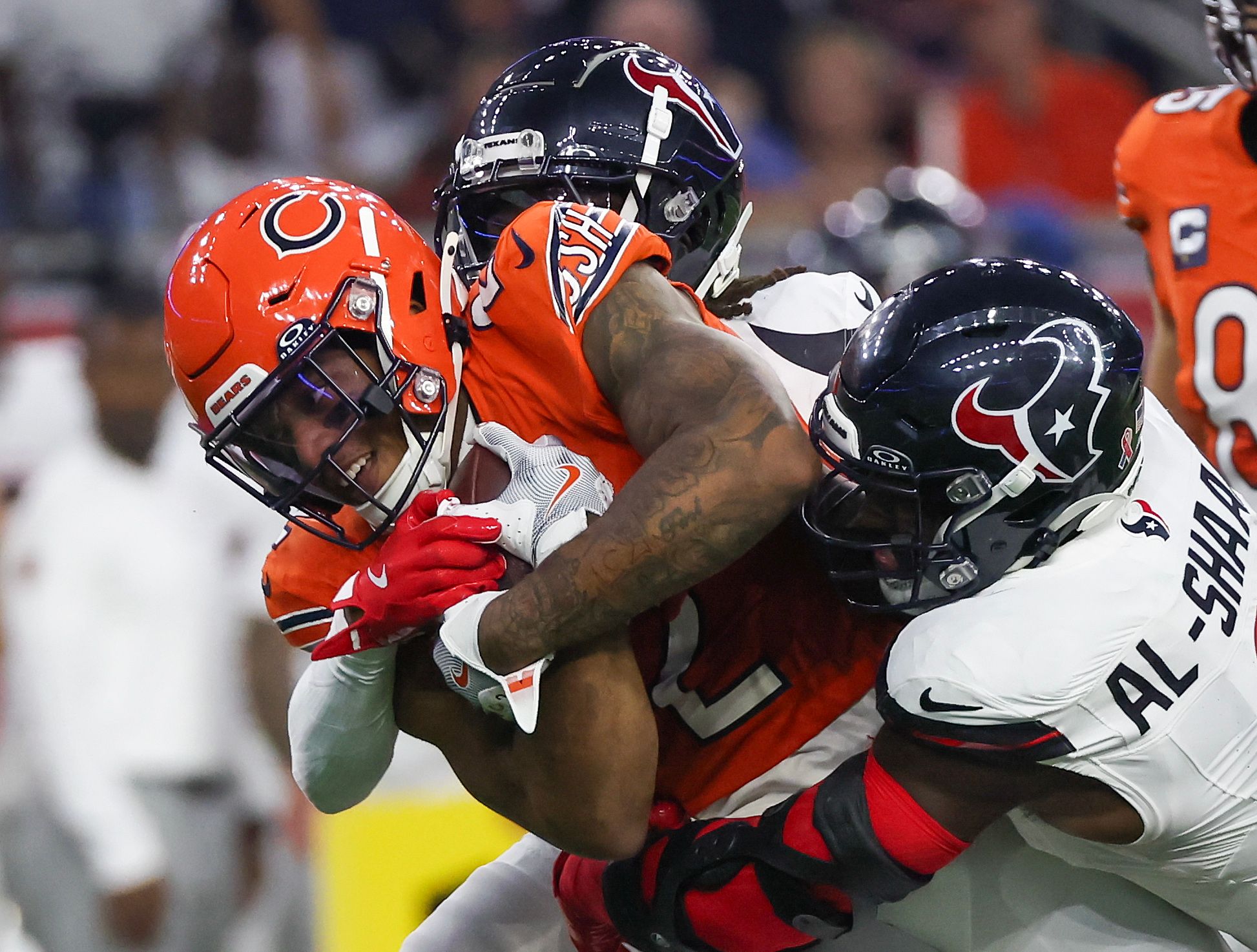 Sep 15, 2024; Houston, Texas, USA; Chicago Bears wide receiver DJ Moore (2) is tackled by Houston Texans linebacker Azeez Al-Shaair (0) in the first quarter at NRG Stadium. Mandatory Credit: Thomas Shea-Imagn Images