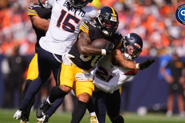 Sep 15, 2024; Denver, Colorado, USA; Pittsburgh Steelers running back Jaylen Warren (30) runs past the tackle of Denver Broncos cornerback Riley Moss (21) in the first quarter at Empower Field at Mile High. Mandatory Credit: Ron Chenoy-Imagn Images