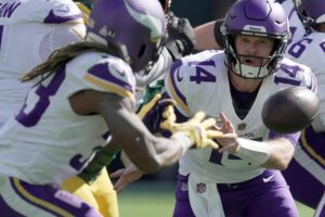 Minnesota Vikings quarterback Sam Darnold (14) pitches the ball to running back Aaron Jones (33) during the third quarter of their game Sunday, September 29, 2024 at Lambeau Field in Green Bay, Wisconsin. The Minnesota Vikings beat the Green Bay Packers 31-29.