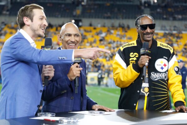 Oct 6, 2024; Pittsburgh, Pennsylvania, USA; NBC Sunday Night Football personalities Jac Collinsworth (left) and Tony Dungy (middle) are joined by recording artist Snoop Dogg (right) on the set before the Pittsburgh Steelers host the Dallas Cowboys at Acrisure Stadium. Mandatory Credit: Charles LeClaire-Imagn Images