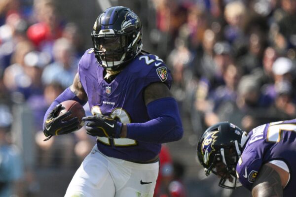 Oct 13, 2024; Baltimore, Maryland, USA; Baltimore Ravens running back Derrick Henry (22) rushes during the first half against the Washington Commanders at M&T Bank Stadium. Mandatory Credit: Tommy Gilligan-Imagn Images