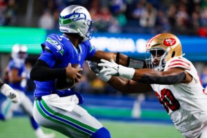 Oct 10, 2024; Seattle, Washington, USA; Seattle Seahawks quarterback Geno Smith (7) steps away from pressure from San Francisco 49ers defensive tackle Kevin Givens (90) during the third quarter at Lumen Field. Mandatory Credit: Joe Nicholson-Imagn Images