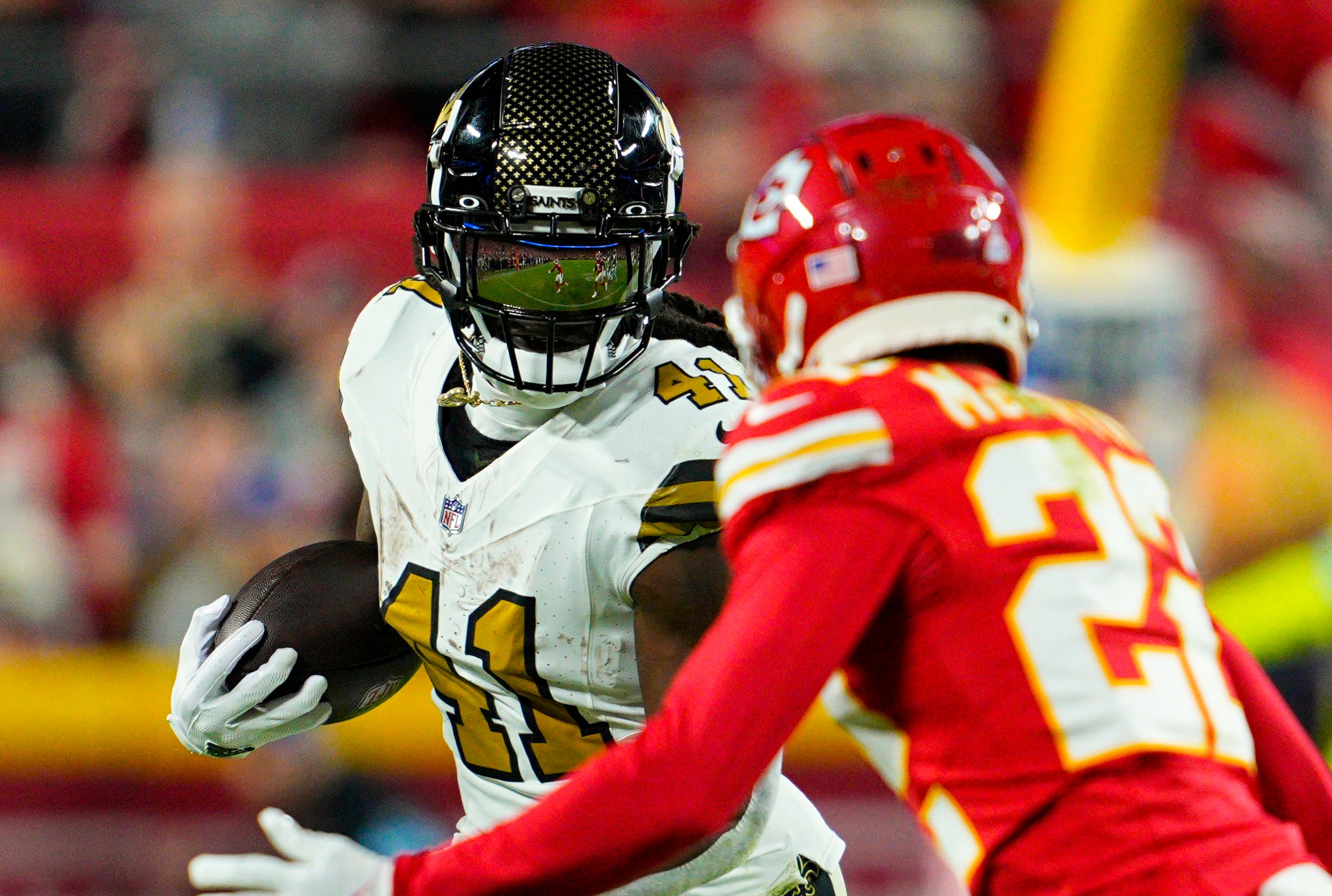Oct 7, 2024; Kansas City, Missouri, USA; New Orleans Saints running back Alvin Kamara (41) runs the ball against Kansas City Chiefs cornerback Trent McDuffie (22) during the second half at GEHA Field at Arrowhead Stadium. Mandatory Credit: Jay Biggerstaff-Imagn Images