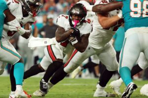 Aug 23, 2024; Tampa, Florida, USA; Tampa Bay Buccaneers running back Bucky Irving (7) runs with the ball against the Miami Dolphins during the second quarter at Raymond James Stadium. Mandatory Credit: Kim Klement Neitzel-USA TODAY Sports