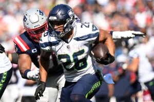 Sep 15, 2024; Foxborough, Massachusetts, USA; Seattle Seahawks running back Zach Charbonnet (26) rushes against the New England Patriots during the second half at Gillette Stadium. Mandatory Credit: Brian Fluharty-Imagn Images