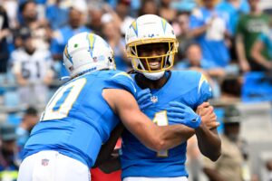 Sep 15, 2024; Charlotte, North Carolina, USA; Los Angeles Chargers wide receiver Quentin Johnston (1) celebrates with quarterback Justin Herbert (10) after scoring a touchdown in the first quarter at Bank of America Stadium. Mandatory Credit: Bob Donnan-Imagn Images