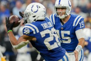 Indianapolis Colts quarterback Joe Flacco (15) tosses the ball to Indianapolis Colts running back Jonathan Taylor (28) on Sunday, Sept. 29, 2024, during a game against the Pittsburgh Steelers at Lucas Oil Stadium in Indianapolis.