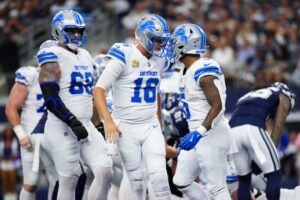 Oct 13, 2024; Arlington, Texas, USA; Detroit Lions running back David Montgomery (5) celebrates with Detroit Lions quarterback Jared Goff (16) after scoring a touchdown during the first half against the Dallas Cowboys at AT&T Stadium. Mandatory Credit: Kevin Jairaj-Imagn Images