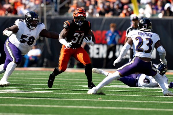 Cincinnati Bengals halfback Zack Moss (31) runs downfield as Baltimore Ravens inside linebacker Trenton Simpson (23) and Baltimore Ravens nose tackle Michael Pierce (58) tackle him in the third quarter of the NFL game at Paycor Stadium in Cincinnati on Sunday, Oct. 6, 2024. © Albert Cesare/The Enquirer / USA TODAY NETWORK via Imagn Images