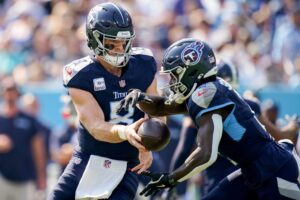 Tennessee Titans quarterback Will Levis (8) hands off to running back Tyjae Spears (2) during the first quarter against the Indianapolis Colts at Nissan Stadium in Nashville, Tenn., Sunday, Oct. 13, 2024.
