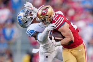 Jan 28, 2024; Santa Clara, California, USA; San Francisco 49ers running back Christian McCaffrey (23) stiff arms Detroit Lions safety C.J. Gardner-Johnson (2) during the first half of the NFC Championship football game at Levi's Stadium. Mandatory Credit: Kyle Terada-USA TODAY Sports