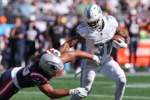 Oct 6, 2024; Foxborough, Massachusetts, USA; Miami Dolphins running back Raheem Mostert (31) runs the ball during the first half against the New England Patriots at Gillette Stadium. Mandatory Credit: Paul Rutherford-Imagn Images